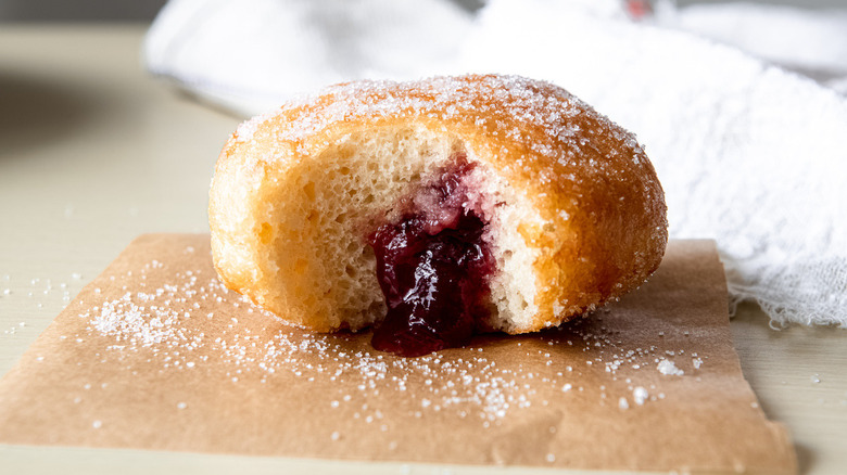 jelly-filled sugar coated donut on parchment paper