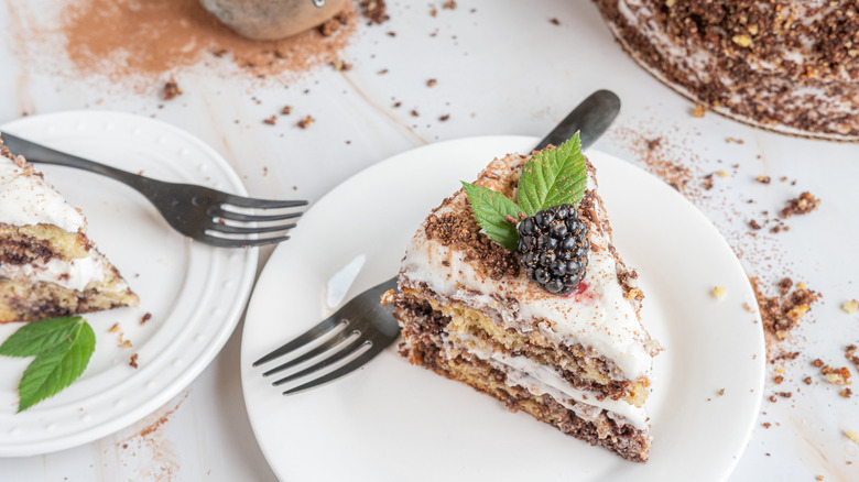 marble cake slice on plate with blackberry on top