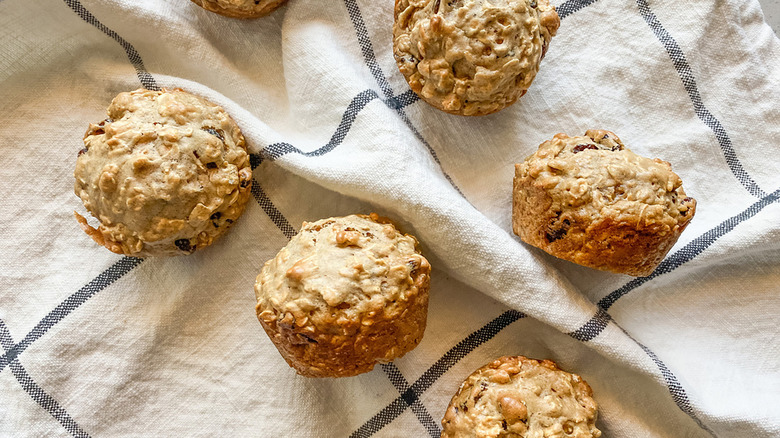 Oatmeal raisin muffins on a tea towel