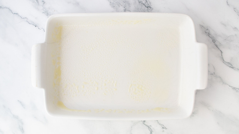 Greased casserole dish on countertop