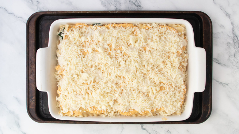 Pumpkin lasagna in casserole dish on top of baking sheet