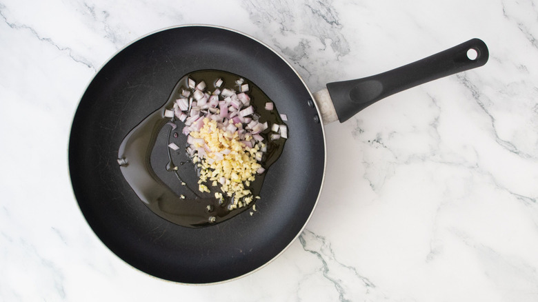Minced garlic and shallot in skillet with oil