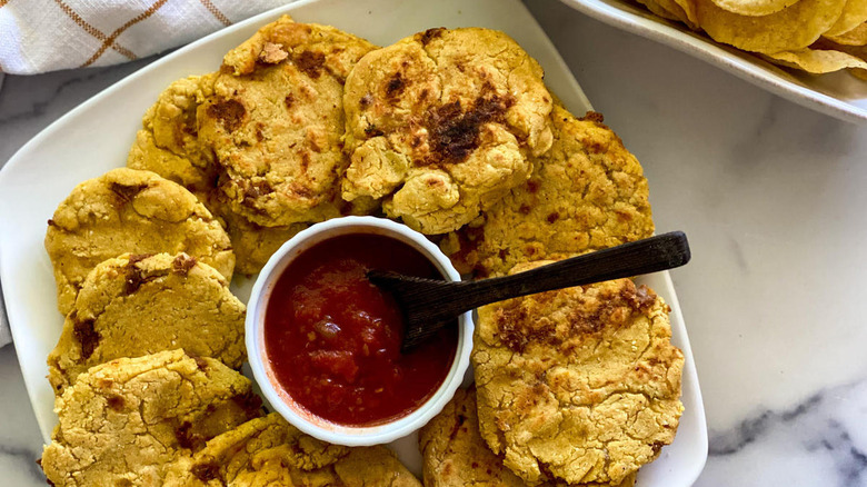 Plated pupusas with tomato salsa