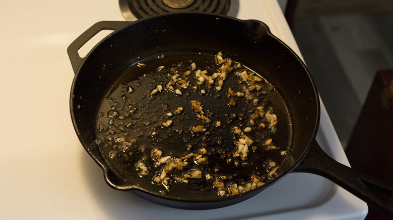garlic cooking in iron pan