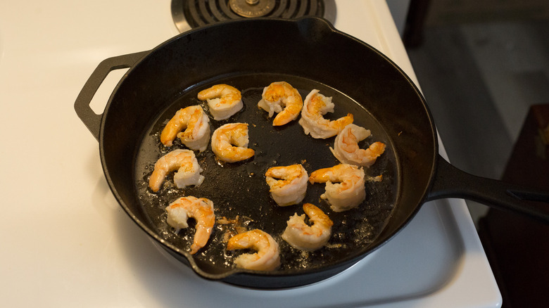 shrimp cooking in iron pan