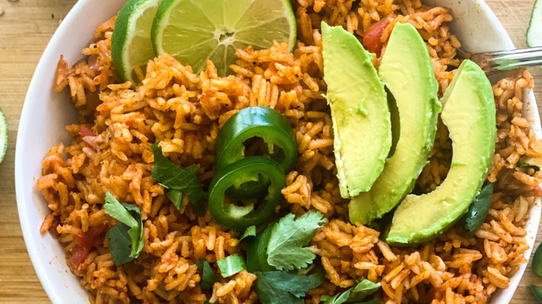 Instant Pot Spanish rice topped with slices of avocado and lime