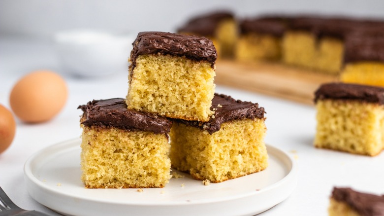 Frosted yellow cake squares on plate