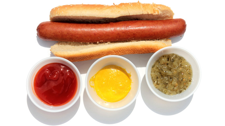 Hot dog on bun with condiments