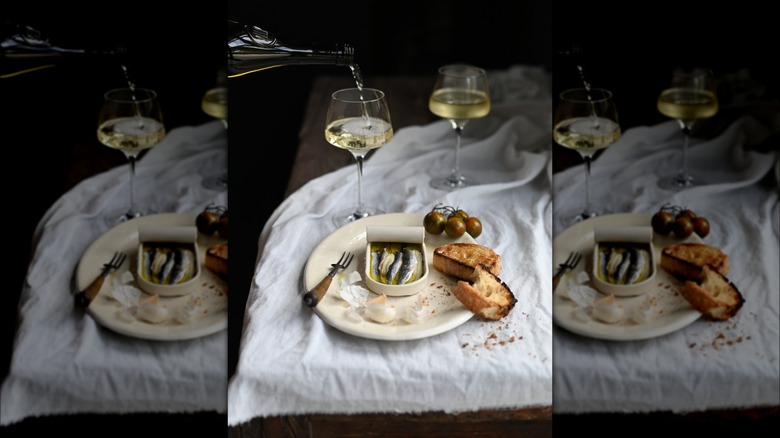 tinned fish, bread, and wine
