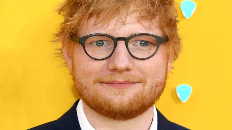 Ed Sheeran in front of yellow background