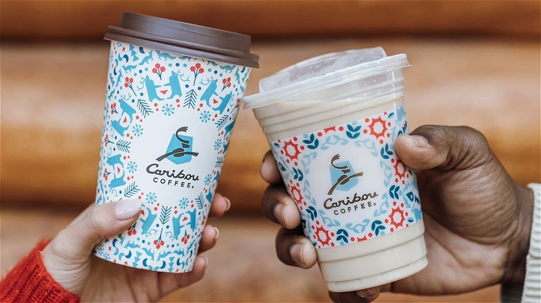 Caribou Coffee cups in hands