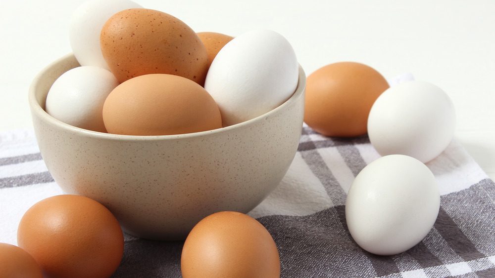 A bowl of white and brown eggs