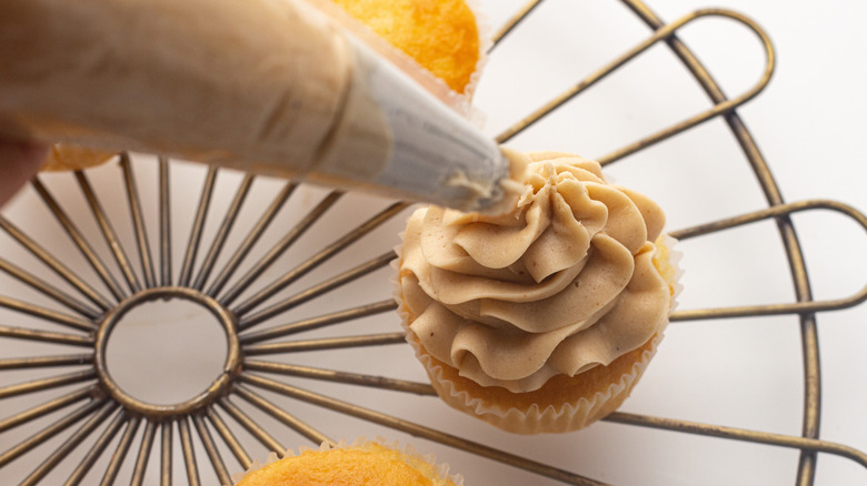 frosting a cupcake
