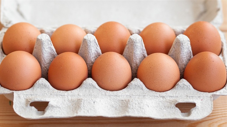 tray of brown eggs in a paper carton