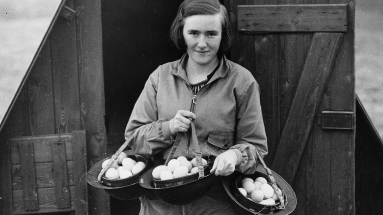 Girl carrying eggs in helmets