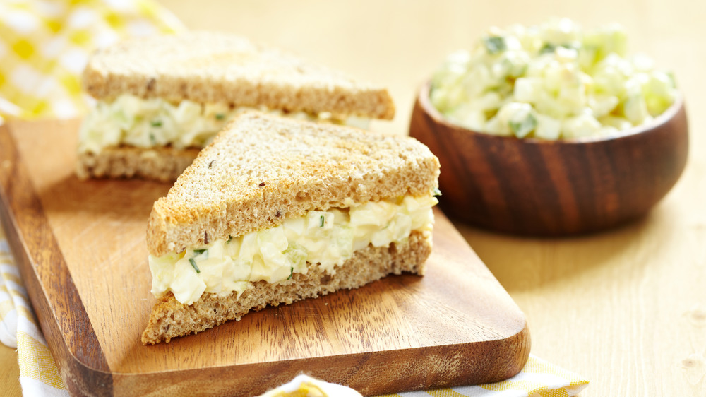 Egg salad sandwich on a board