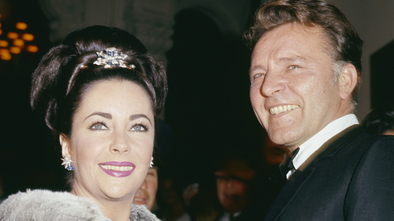 Elizabeth Taylor and Richard Burton smiling in formal attire