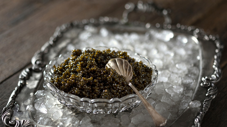 A fancy bowl of caviar on ice