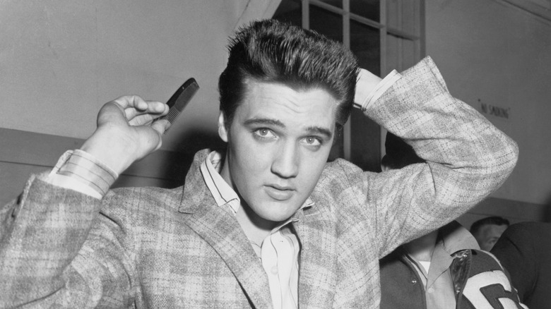 Elvis Presley combing his hair