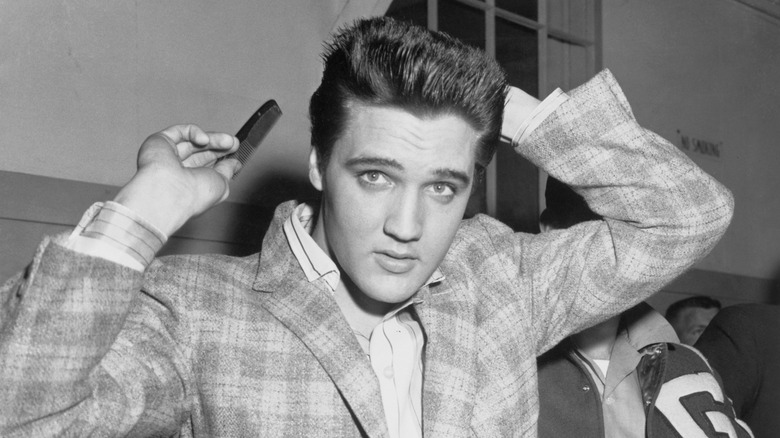 Elvis Presley styling his hair
