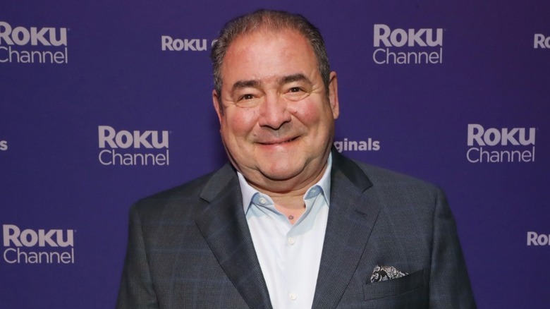 Emeril Lagasse smiling at red carpet event.