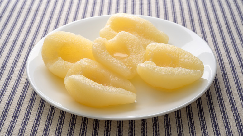 Pears from a can on a white plate