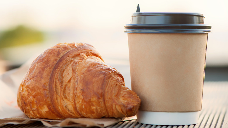 Takeout coffee cup and pastry