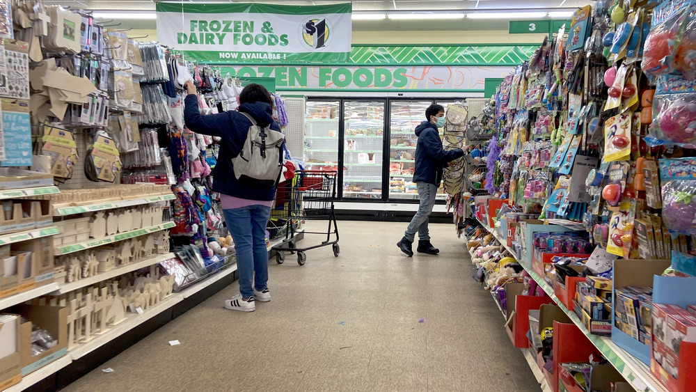 People shopping in an aisle at Dollar Tree