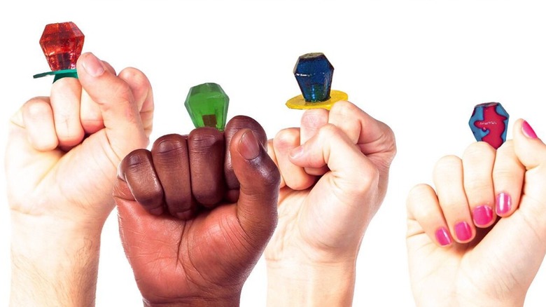 Hands in fists with ring pops