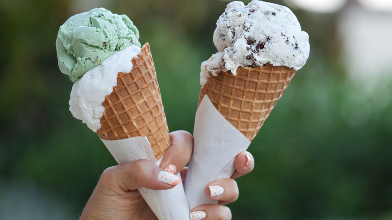 holding two ice cream cones