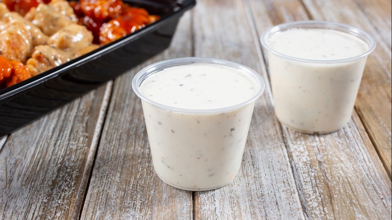 Ranch dressing cups near chicken