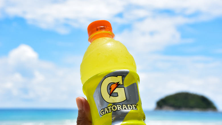 bottle of yellow gatorade, beach background