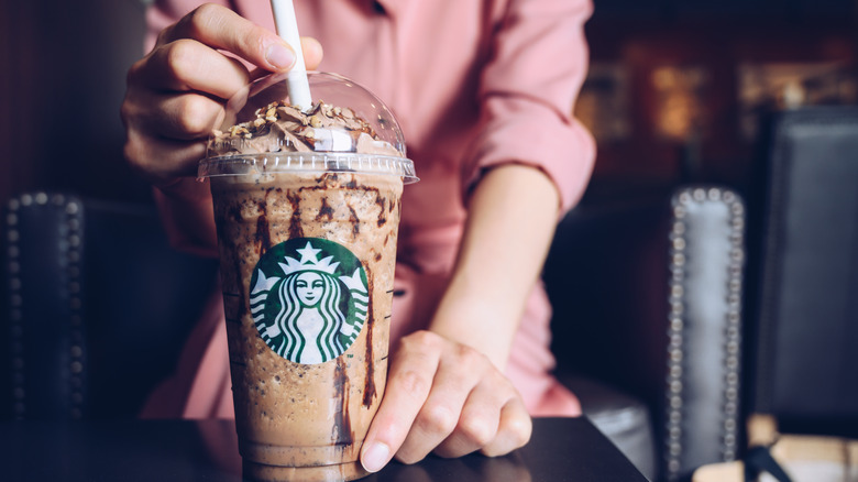 Person holding Starbucks drink