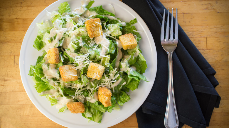 plated caesar salad with croutons, dressing & shredded parm