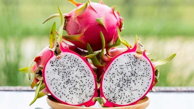 Halved and whole dragon fruit