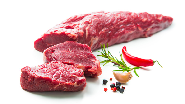 raw beef tenderloin on a white background