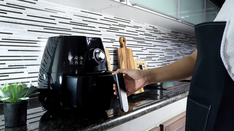 Air fryer being opened in a kitchen