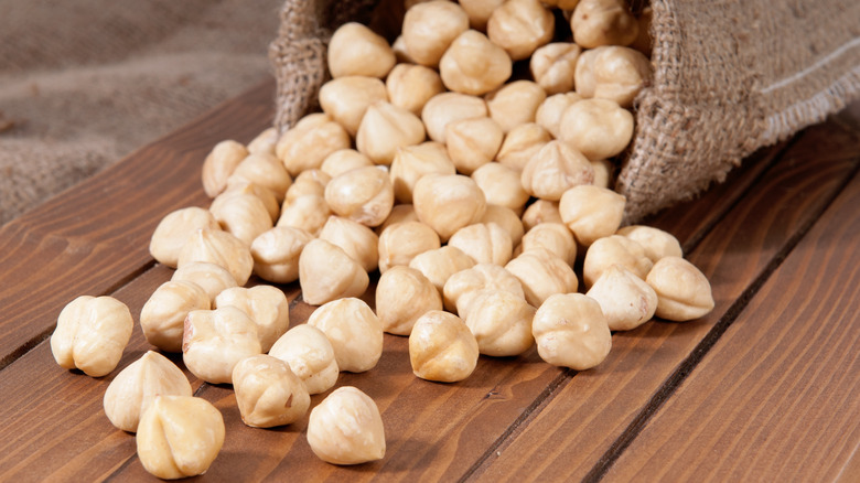 hazelnuts spilling from rustic bag