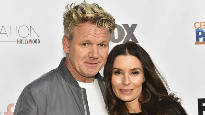 Gordon Ramsay and his wife Tana smiling on the red carpet