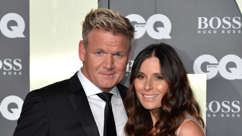 Tana and Gordon Ramsay smiling on the red carpet