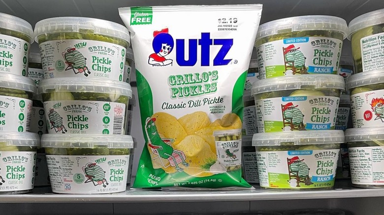 A bag of Utz x Grillo's chips next to stacks of pickles