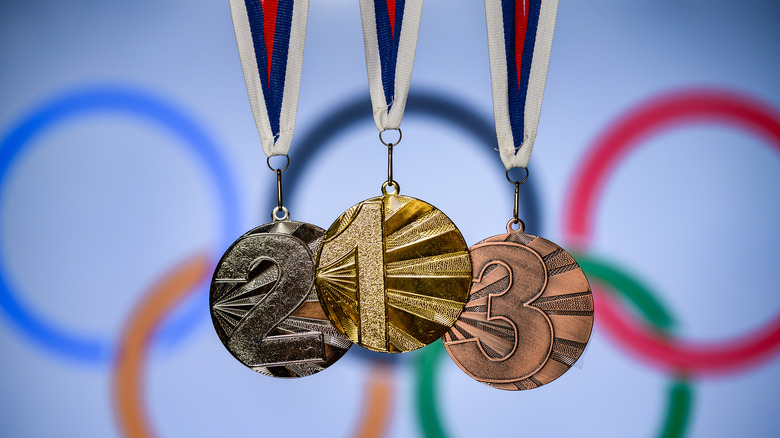 Olympic medals against logo backdrop