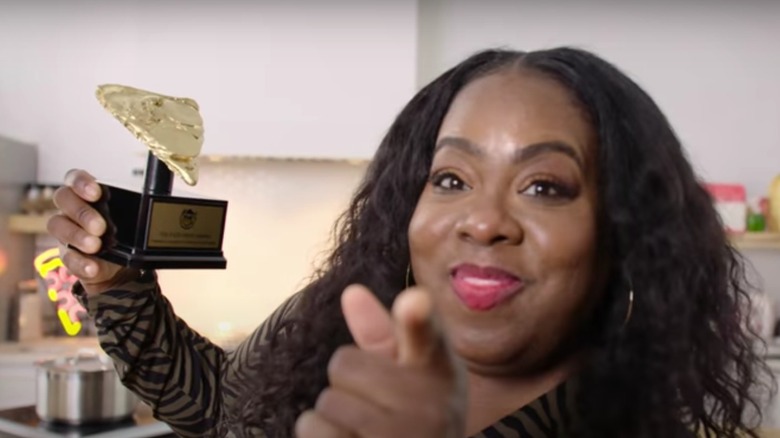 Nicole Russell holds a trophy from the show