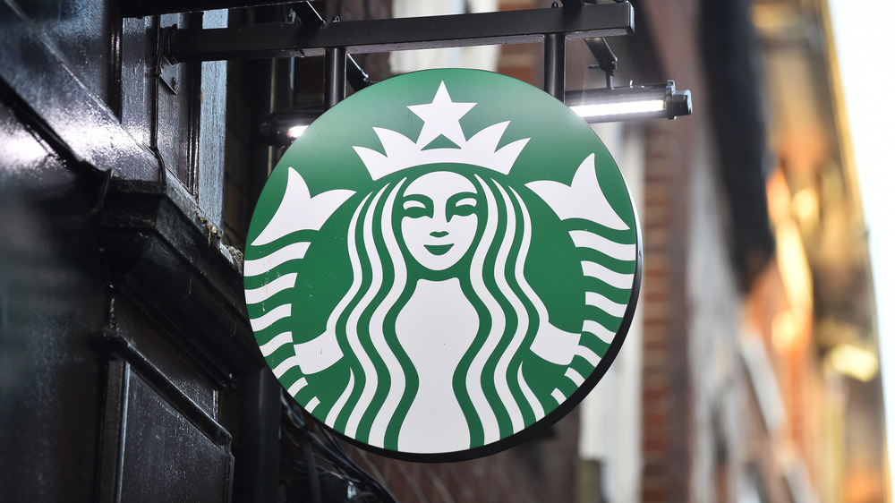 Hanging Starbucks sign in a city