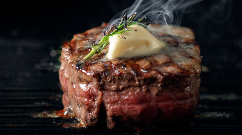 steaming steak with butter