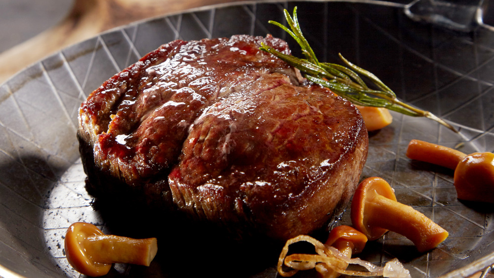 Venison in a pan with rosemary and mushrooms