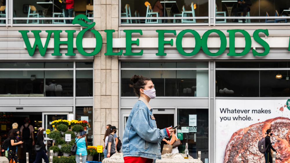 Whole Foods signage, customer wearing mask