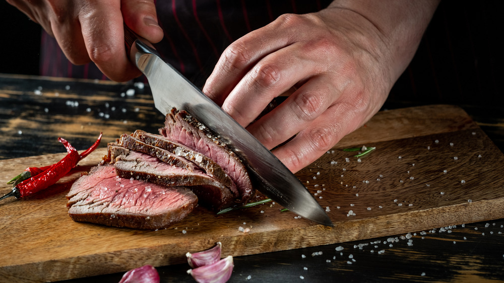 someone cutting a steak