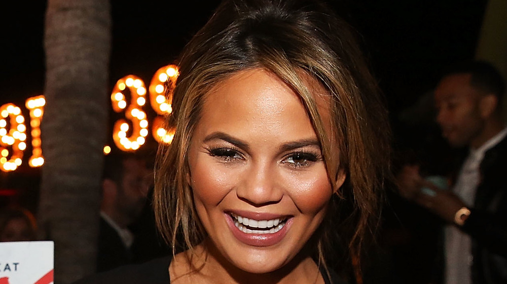 Chrissy Teigen smiling at event