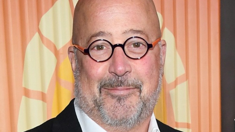 Andrew Zimmern smiling slightly